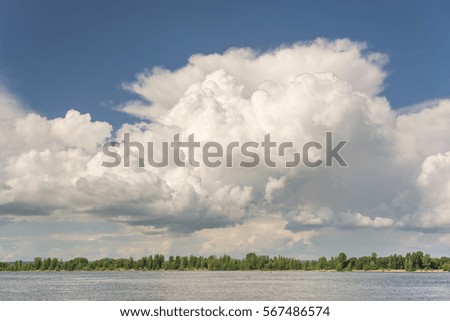Fluffy white clouds on a blue sky, background