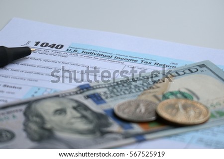 Tax form with dollar cash and pen, tax season and accounting finance concept