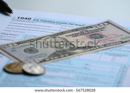 Tax form with dollar cash and pen, tax season and accounting finance concept