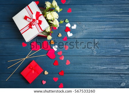Gift boxes with flowers on wooden table