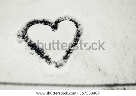 The symbol of the heart, painted on the fresh white snow