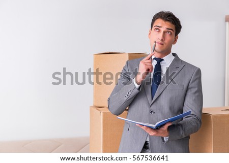 Man signing for the delivery of boxes