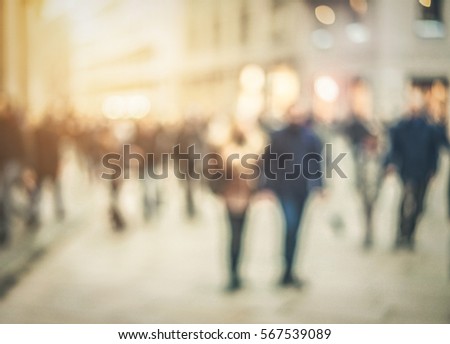 Blurred people walking in the street with back sun light - Defocused image - Rush and metropolis concept - Warm matte filter with soft vignette
