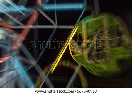 Blurred zoom of a amusement park is a popular in a temple festival carnival at Bangkok Thailand.