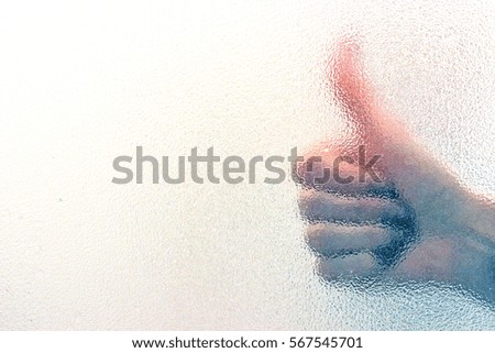 COOL hand sign behind the glass