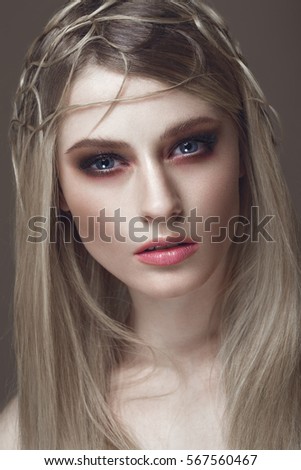 Beautiful fashion woman with creative make-up and hairstyle. The beauty of the face. Photos shot in the studio.