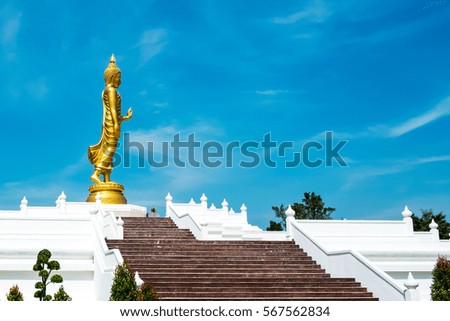 Standing Buddha Statue in blue sky at Anu Phutthamonthon, a public Buddhist park located in Samut Sakhon, a neighbour of Bangkok to the west, is one of the country's smallest provinces of Thailand.