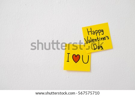 drawing "happy valentine's day" and "i love you" on yellow paper
