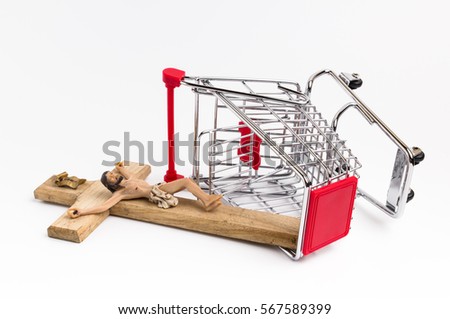 Shopping cart overturned with crucifix on the ground. Conceptual representation of religion, loss of faith, blasphemy.