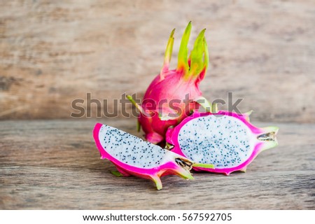 Healthy dragon fruits on old wooden background.
