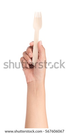 hand holding wood fork isolated on white background