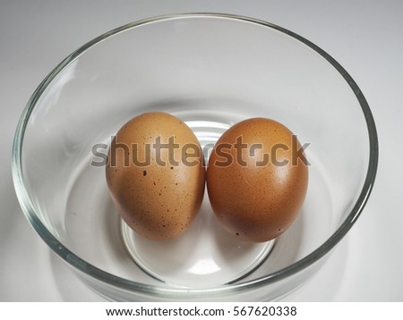 two eggs in glass bowl for cooking