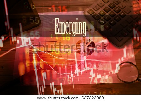 Emerging - Hand writing word to represent the meaning of financial word as concept. A word Emerging is a part of Investment&Wealth management in stock photo.