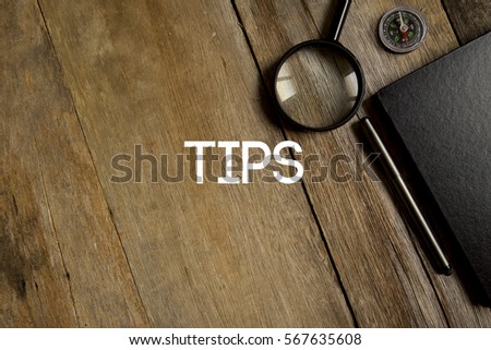 TIPS CONCEPT ON WOODEN BACKGROUND