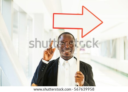 african man pointing with arrow