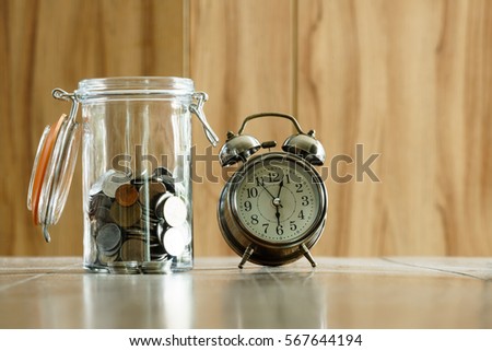 Coins and Clock in savings and investment growth time concept