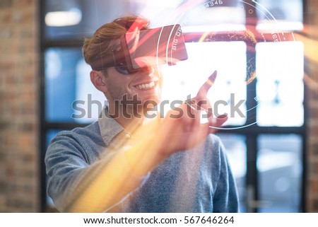Digital image of planet with big data text against businessman using virtual reality headset in office