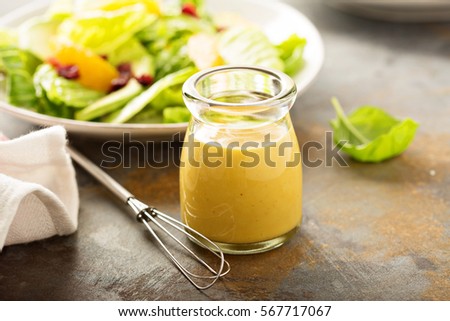 Homemade honey mustard salad dressing in a jar Royalty-Free Stock Photo #567717067
