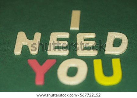 The word spelling to "I need you" on green background, Sensitive Focus