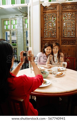 Woman taking pictures of friends