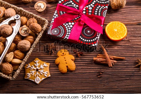 Gingerbread, walnuts and gift on a wooden table