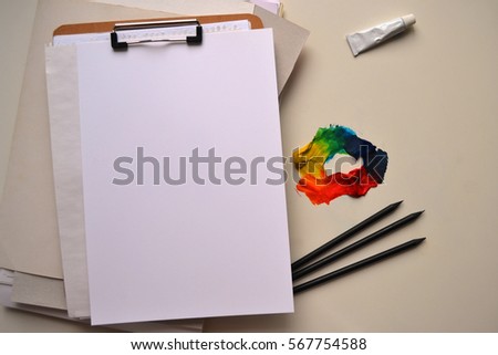 desktop mockup. artistic work tools. sheets of paper, watercolor/acrylic paint, paint brush. top view