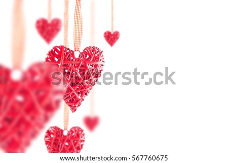 Few red hearts on the ribbon on a white background. Valentine's Day.