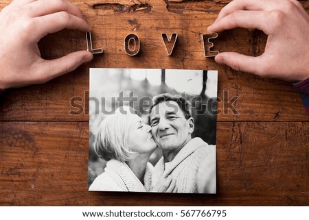 Hands creating Love sign. Picture of senior couple. Studio shot,