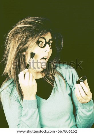 Nerdy woman applying makeup cheekbones, beauty and fashion