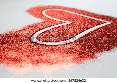 Red glitter heart on a white background for Valentines Day 