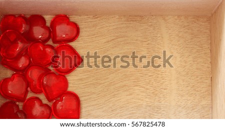 Valentine Hearts in Wooden Box - Photograph of red Valentine hearts in a small wooden box, with space on the side for text or embellishments.  