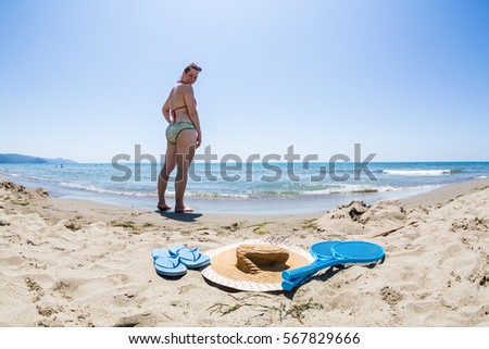 View of a girl at the beach of the Tyrrhenian sea in the Italian region Tuscany