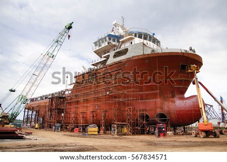 Shipyard industry ,( ship building) Big ship on floating dry dock in shipyard.
located at Port Klang , Malaysia Royalty-Free Stock Photo #567834571