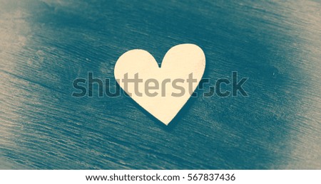Bright heart on a vintage wooden background, retro style