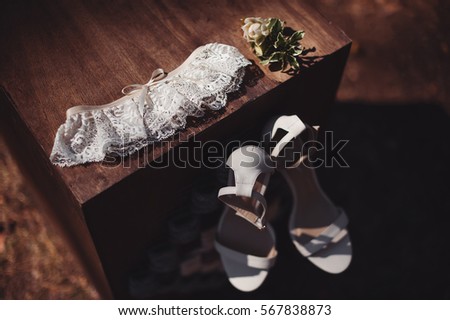 wedding accessories. bridal shoes, garter and boutonniere. vintage picture