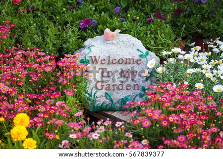 Welcome sign among beautiful flowers