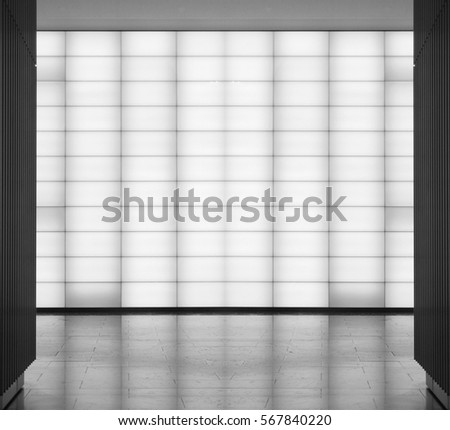 Matte semitransparent glass block wall. Modern architecture in soft light. Black and white photo of public / office building interior or exterior fragment. Abstract architectural background.