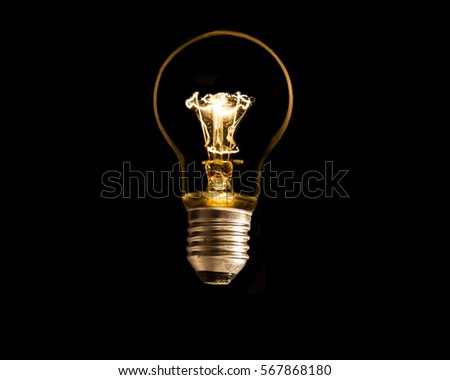 A lit light bulb isolated on black 
