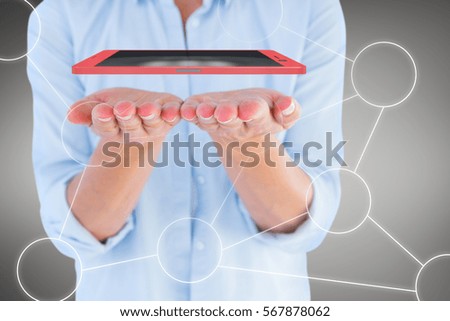 Womans hands presenting against grey vignette 3d