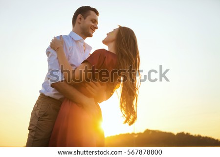 Lovers couple in love having fun dating on beach portrait. Beautiful healthy young girlfriend hugging happy boyfriend, healthy relationship concept Royalty-Free Stock Photo #567878800