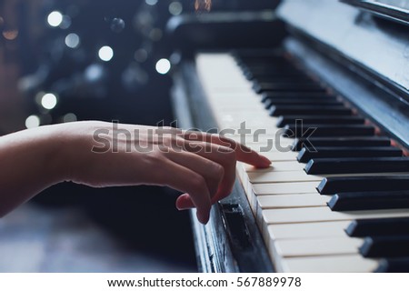girl playing on an old piano vintage