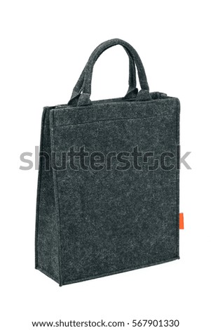 Side view of gray felt-fabric female bag. Isolated on white background. Royalty-Free Stock Photo #567901330