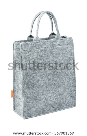 Side view of gray felt-fabric female bag. Isolated on white background. Royalty-Free Stock Photo #567901369