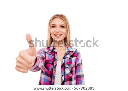 Happy young smiling girl gesturing and showing thumb up.