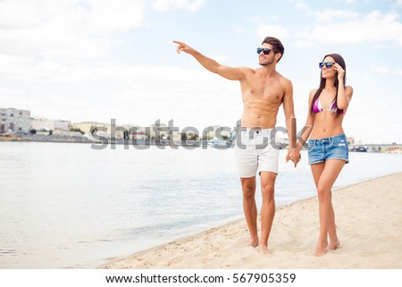 Happy romantic family  having honeymoon and walking on beach.