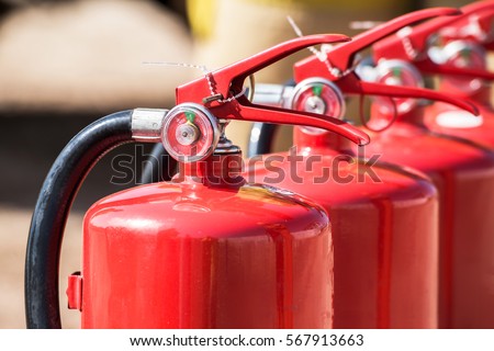 Red tank of fire extinguisher. Overview of a powerful industrial fire extinguishing system. Emergency equipment for industrial refinery crude oil and gas.compressed gas carbon dioxide in side. Fire Royalty-Free Stock Photo #567913663