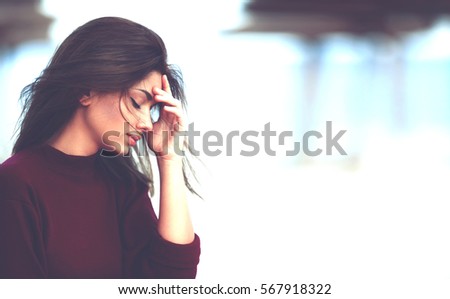 Girl With Hand on the Head. Sad Pensive Teenage Girl Royalty-Free Stock Photo #567918322
