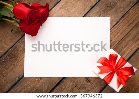Red roses, gift box and Valentine's day greeting card