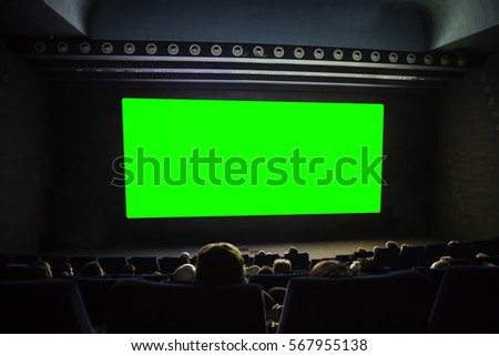 cinema auditorium with heads, chairs and green projection screen. Ready for adding your own picture.