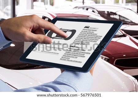 Man using tablet pc against view of row new car